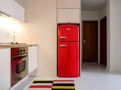 a red refrigerator in a kitchen with a stove at Host2U Art AP - Fireplace - Free parking - 5min Gondola in Bansko