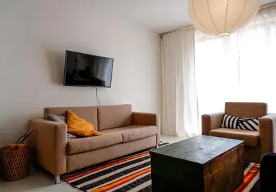 a living room with a couch and a coffee table at Host2U Art AP - Fireplace - Free parking - 5min Gondola in Bansko
