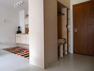 a hallway with a door and a rug in a room at Host2U Art AP - Fireplace - Free parking - 5min Gondola in Bansko