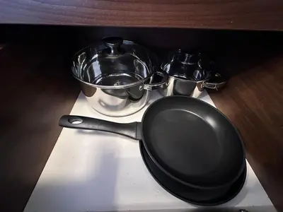 a frying pan and two bowls on a stove at Host2U Belvedere Apartment - Ski in - out - FREE Parking in Bansko