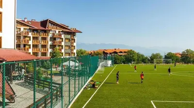 a group of people playing soccer on a soccer field at Host2U Belvedere Apartment - Ski in - out - FREE Parking in Bansko