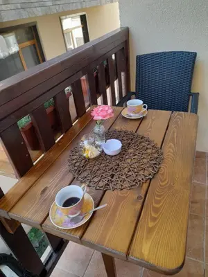 a wooden table with two cups of coffee on it at Снежна приказка Пампорово в хотел Mountain Lodge ап 29 in Pamporovo