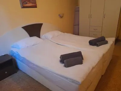 two beds in a bedroom with towels on them at Снежна приказка Пампорово в хотел Mountain Lodge ап 29 in Pamporovo