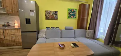 a living room with a couch and a table at Tranquility Lodge, next to Paradise and metro station in Sofia