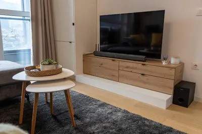 a living room with a large flat screen tv at The View Sofia in Sofia