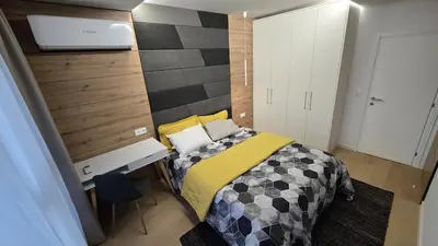 a small bedroom with a bed and a desk at The View Sofia in Sofia