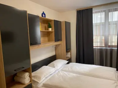 a bedroom with two beds and a window at Castle Inn Pamporovo in Pamporovo
