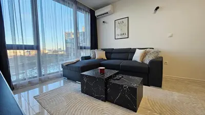 a living room with a couch and a table at Stylish and Modern 1bdrm apt free private parking in Sofia