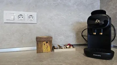 a coffee maker sitting on a counter next to a box at Stylish and Modern 1bdrm apt free private parking in Sofia