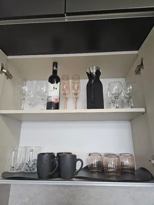 a shelf with wine glasses and wine bottles at Stylish and Modern 1bdrm apt free private parking in Sofia