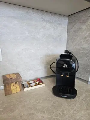 a coffee maker sitting on a counter next to a box of cookies at Stylish and Modern 1bdrm apt free private parking in Sofia