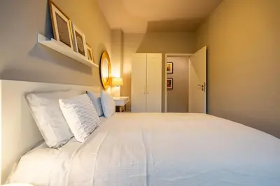 a bedroom with a large bed with white pillows at Stylish 2 BDRM Apt at NDK in Sofia