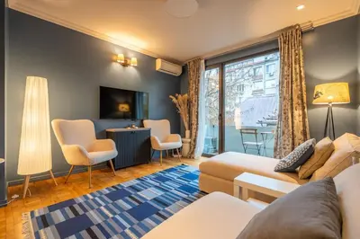 a living room with a couch and a tv at Stylish 2 BDRM Apt at NDK in Sofia