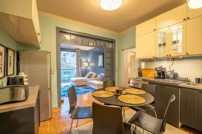 a kitchen with a table and chairs in a room at Stylish 2 BDRM Apt at NDK in Sofia