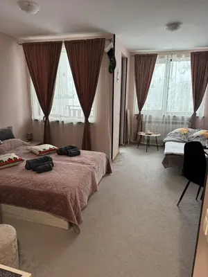 a hotel room with two beds in a room at Borovetz Gardens MVS Apart E28 in Borovets