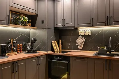 a kitchen with gray cabinets and a stove top oven at All Seasons Apartment in Sofia