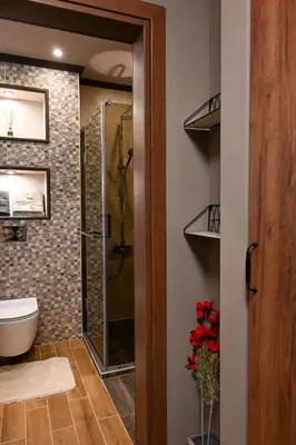 a bathroom with a toilet and a glass shower at All Seasons Apartment in Sofia