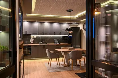 a kitchen with a table and chairs in a room at All Seasons Apartment in Sofia