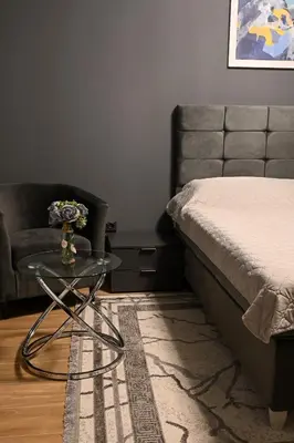 a bedroom with a bed and a table and a couch at All Seasons Apartment in Sofia