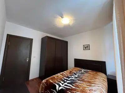 a bedroom with a bed and a ceiling fan at Balkan Heights Apartment in Bansko