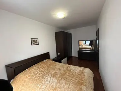 a bedroom with a bed and a mirror in it at Balkan Heights Apartment in Bansko