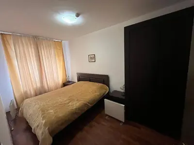 a small bedroom with a bed and a window at Balkan Heights Apartment in Bansko