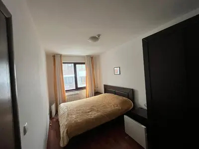 a small bedroom with a bed and a window at Balkan Heights Apartment in Bansko