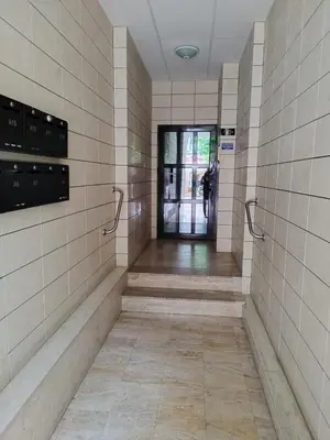 a hallway in a building with a door open at Апартамент Сандански Център in Sandanski