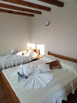 two beds with white towels on top of them at Gologanova house in Kalofer