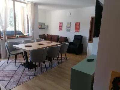 a living room with a table and chairs and a couch at ИН Хоум Комфорт in Borovets