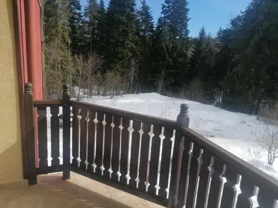 a balcony with a view of a snow covered yard at ИН Хоум Комфорт in Borovets