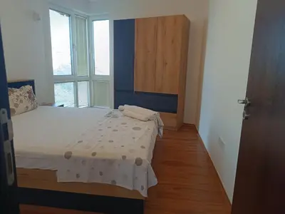 a small bedroom with a bed and a window at Two-bedroom Apartment Lauta 28 in Plovdiv