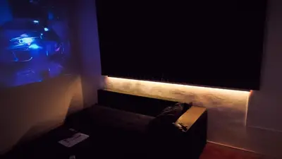 a living room with a couch and a large television at Апартамент Япония in Blagoevgrad