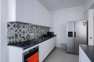 a kitchen with a counter top and a refrigerator at Luminous Central Retreat Spacious 2BD Apartment by Flat Mаnager in Sofia