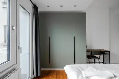 a bedroom with a bed and a desk and a window at Luminous Central Retreat Spacious 2BD Apartment by Flat Mаnager in Sofia
