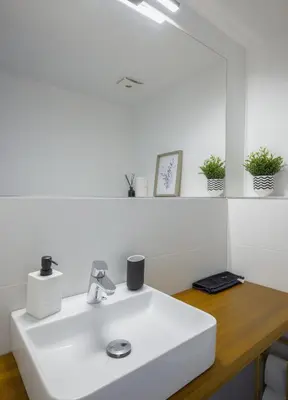 a white sink in a white bathroom with plants at Luminous Central Retreat Spacious 2BD Apartment by Flat Mаnager in Sofia
