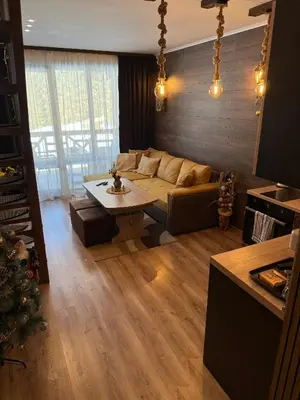 a living room with a couch and a table at From Sunrise to Sunset at Oak Residence Smolyan in Smolyan