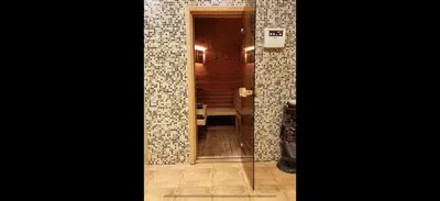 a hallway with a mirror and a cat in a room at From Sunrise to Sunset at Oak Residence Smolyan in Smolyan