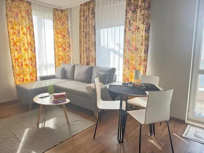 a living room with a couch and a table at Cozy place for nights in Plovdiv