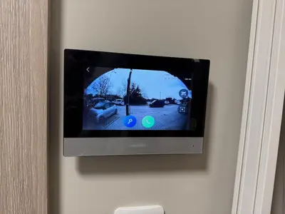 a television on a wall with a picture of a yard at Cozy place for nights in Plovdiv