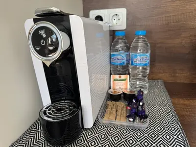 a coffee maker with two bottles of water at Cozy place for nights in Plovdiv