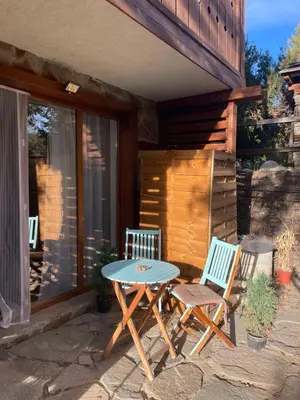 a patio with two chairs and a table on a patio at The New Inn in Bansko