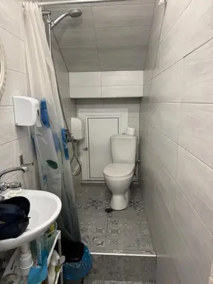 a bathroom with a toilet and a sink at Cozy High-Street Loft in Sofia's Best Central Location in Sofia