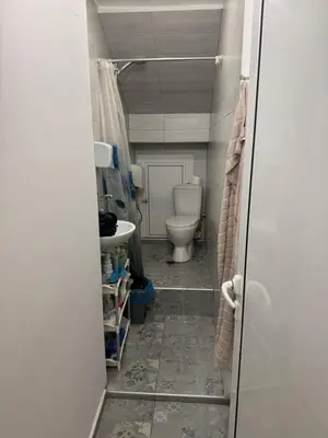 a bathroom with a toilet and a sink at Cozy High-Street Loft in Sofia's Best Central Location in Sofia