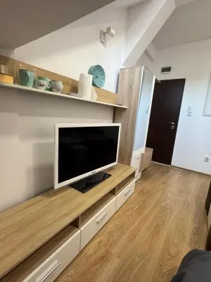 a living room with a flat screen tv on a wall at Cozy High-Street Loft in Sofia's Best Central Location in Sofia