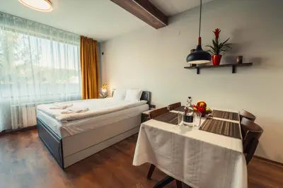 a hotel room with a bed and a table and a table and a bed at Mirror Lake Studio in Samokov