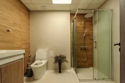 a bathroom with a toilet and a glass shower at Mirror Lake Studio in Samokov