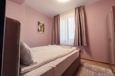 a bed in a room with a window at Rila Family Haven in Samokov