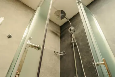 a shower with a shower head in a bathroom at Rila Family Haven in Samokov