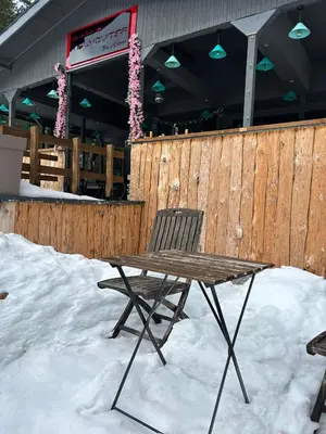 a wooden table and a chair in the snow at Quattro Malyovitsa- Мальовица in Govedartsi